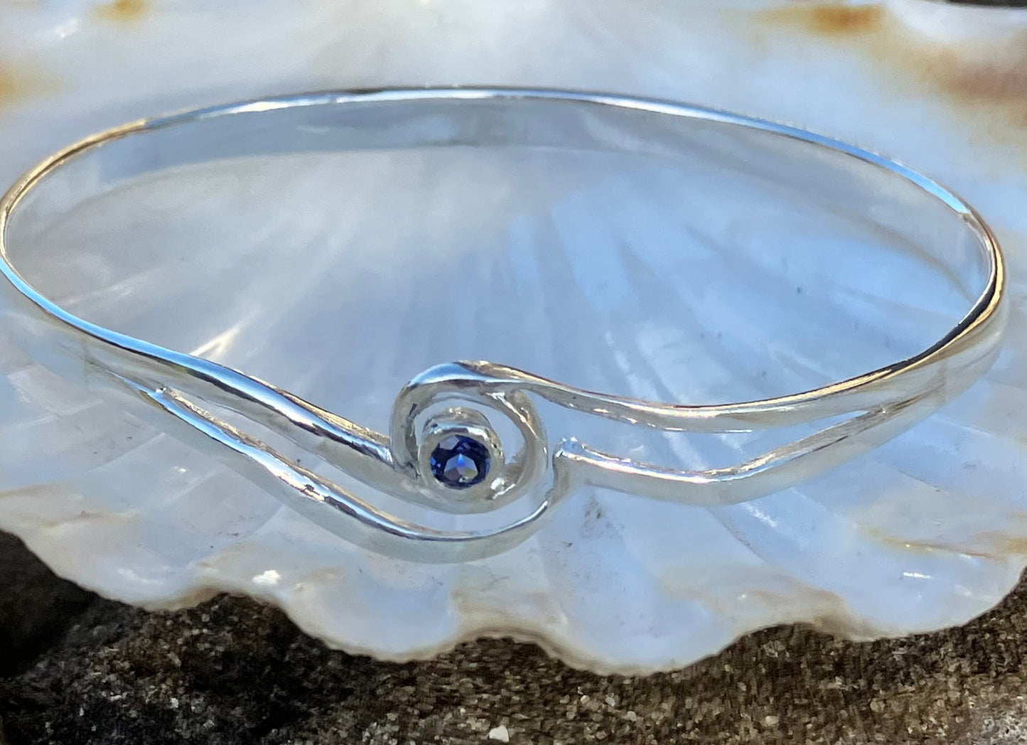 Silver bangle with blue sapphire