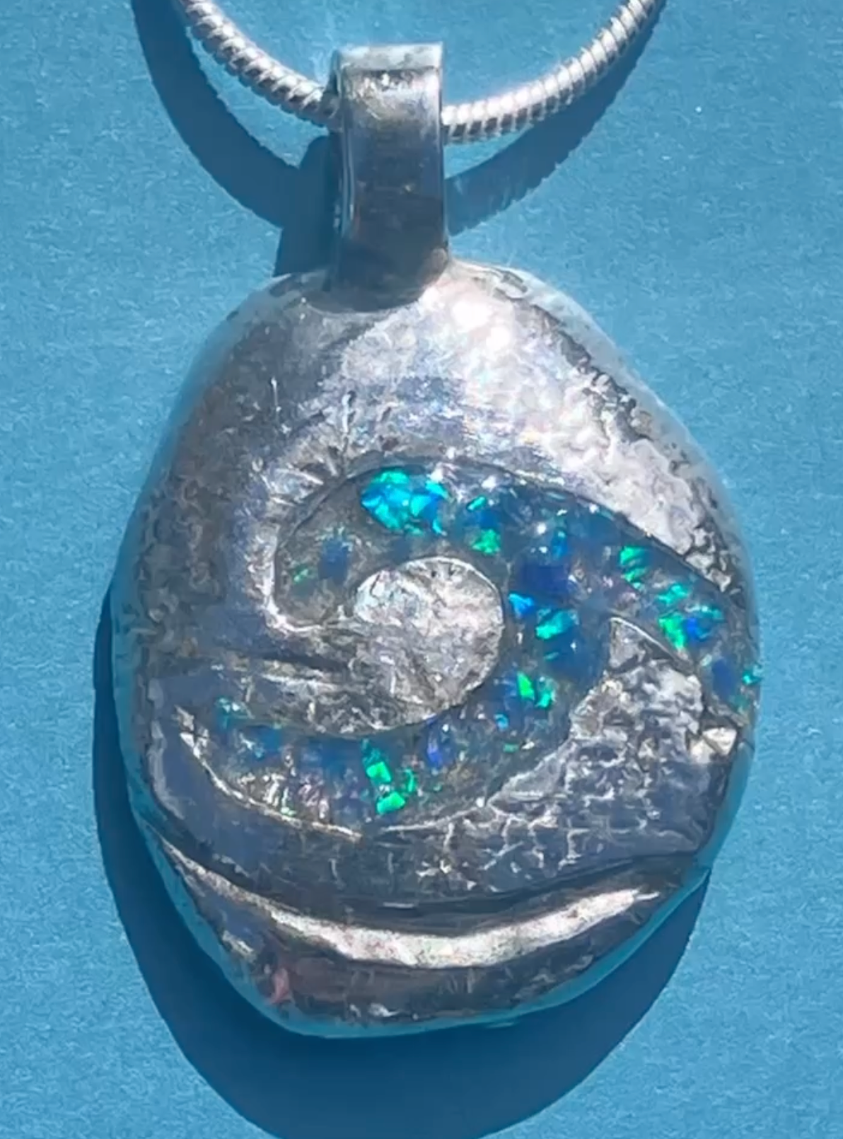 Silver pebble necklace with resin opal wave inlay