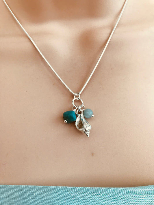 Silver whelk shell necklace with aqua coloured beads