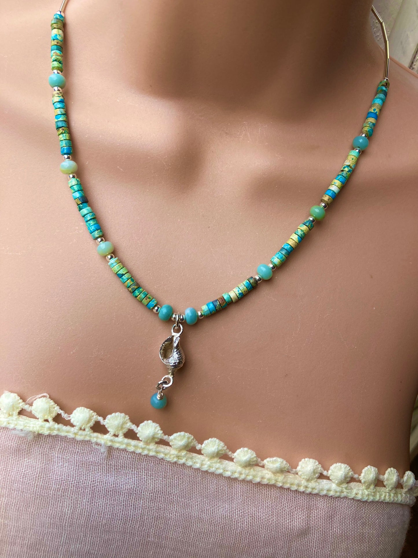 Whelk shell and turquoise coloured necklace