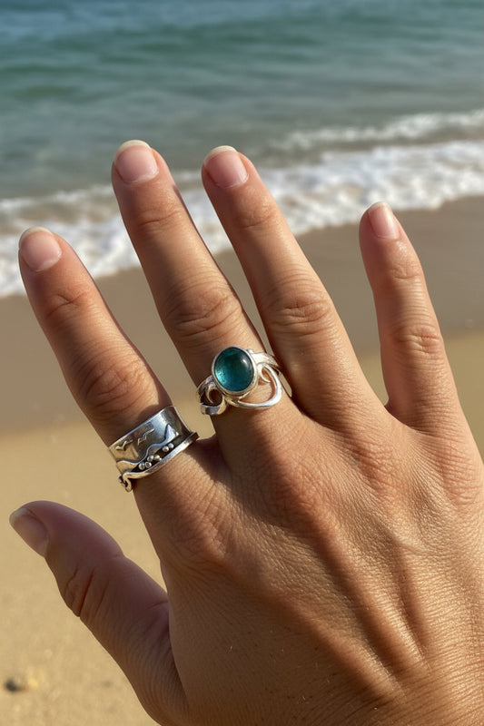 seaglass ring with silver waves on a models hand 