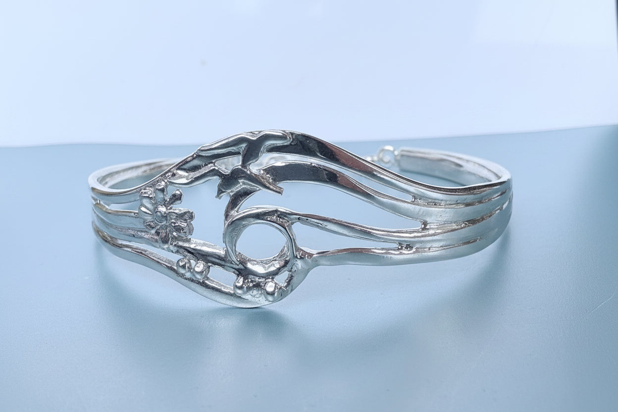 Silver bracelet on a light blue background