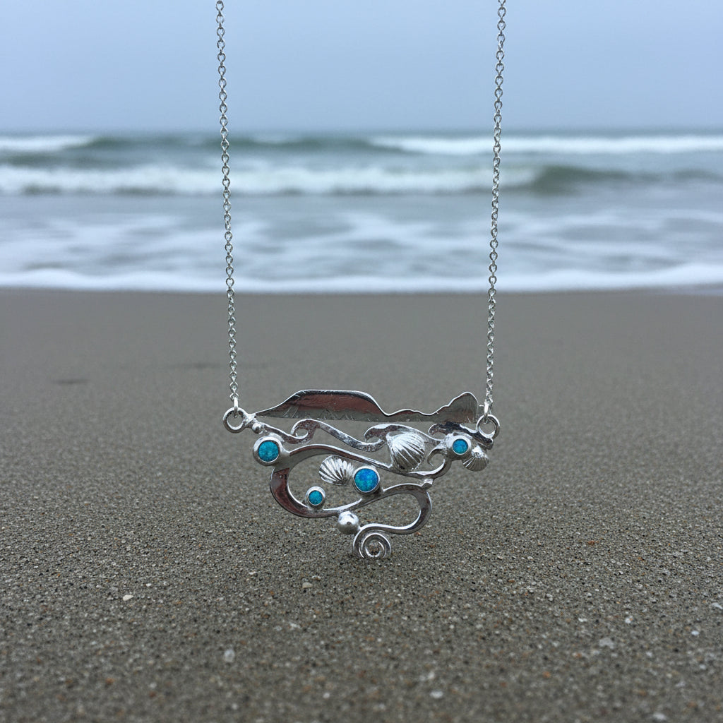 Silver Worms Head landscape necklace with featuring waves swirling currents, blue manmade opals and cockle shells in solid silver 