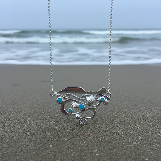 Silver Worms Head landscape necklace with featuring waves swirling currents, blue manmade opals and cockle shells in solid silver 