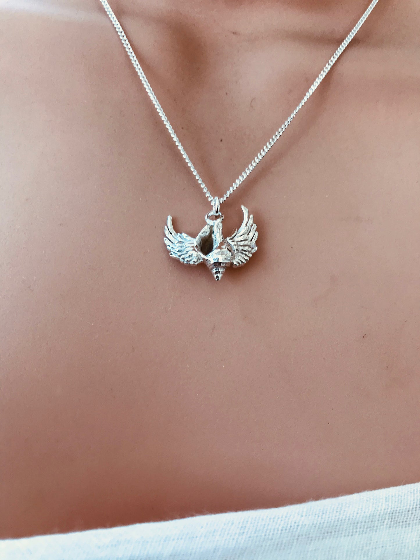 Whelk shell with wings necklace