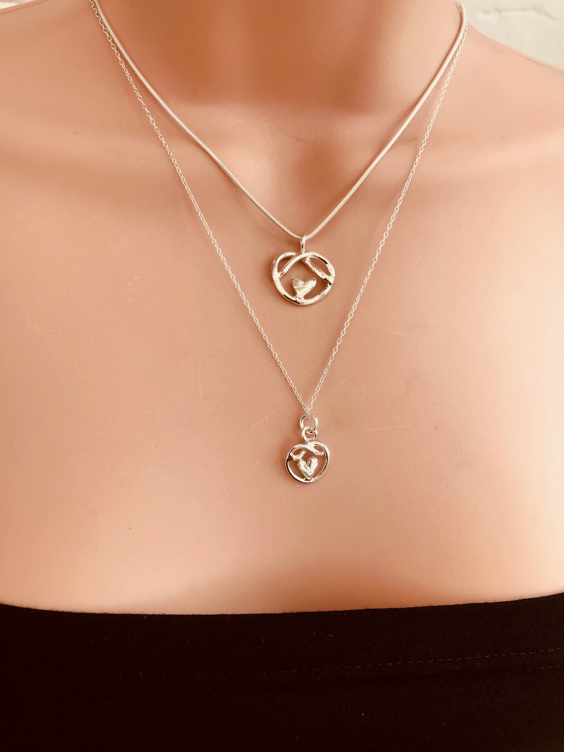 Small and medium heart knot necklaces