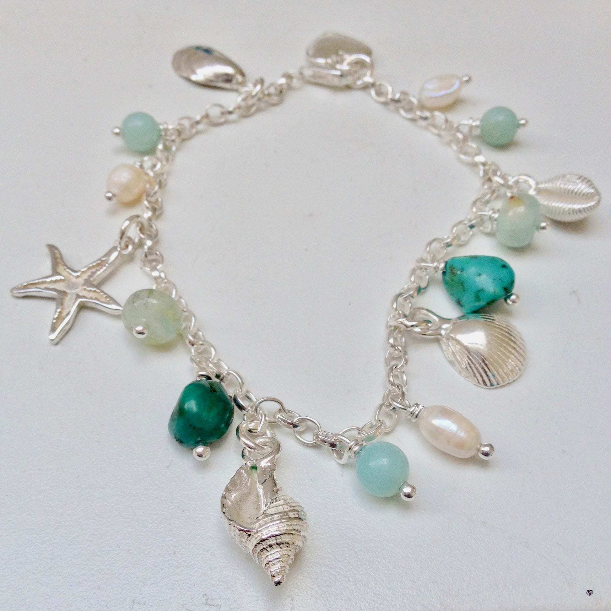 Sea shell bracelet with pearls and aqua coloured beads