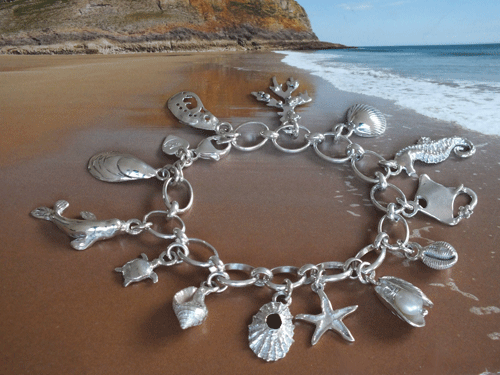 Silver charm bracelet with seashells